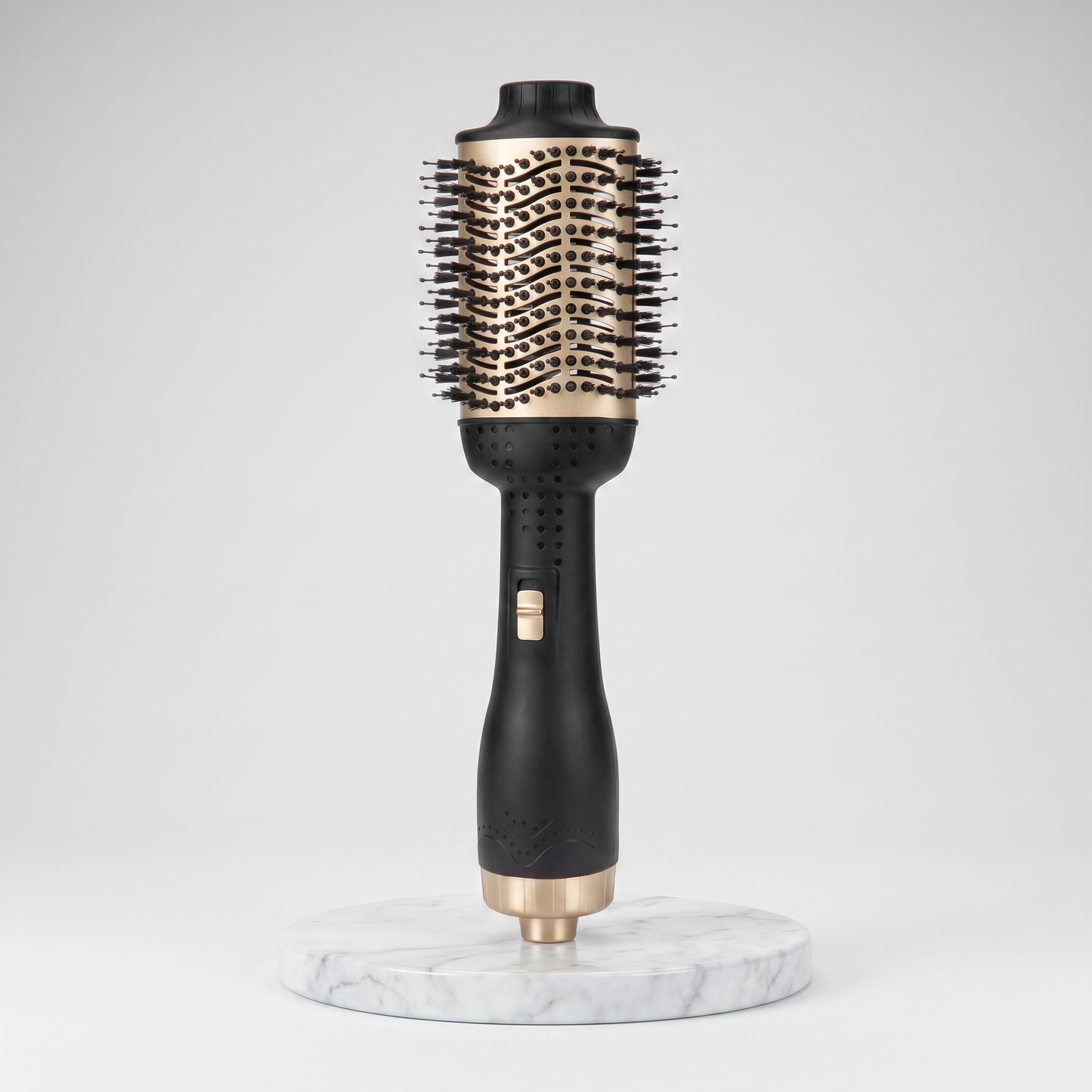 Hot air brush anti-frizz straightener in black and gold on a marble pedestal