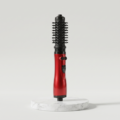 Rotating hot air brush hair styler in red on a marble pedestal